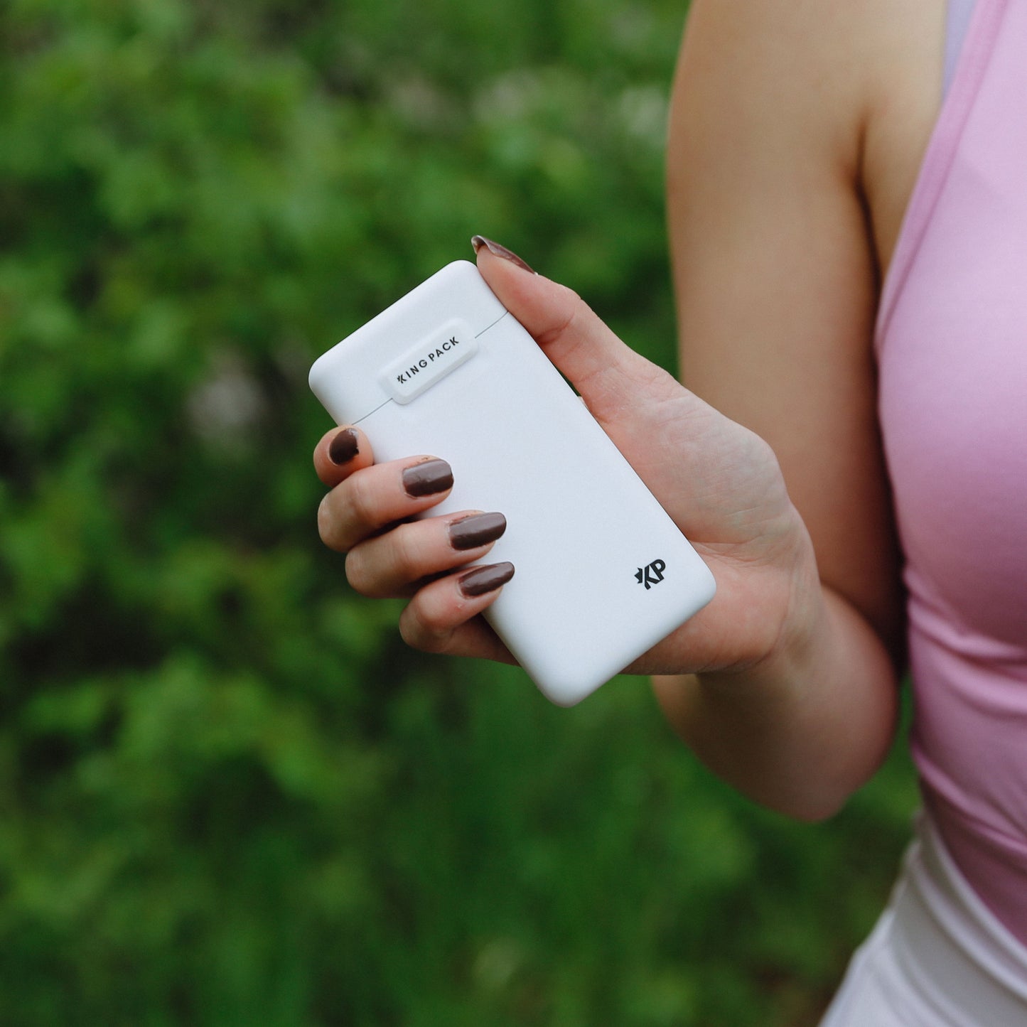 person holding matte white kingpack case